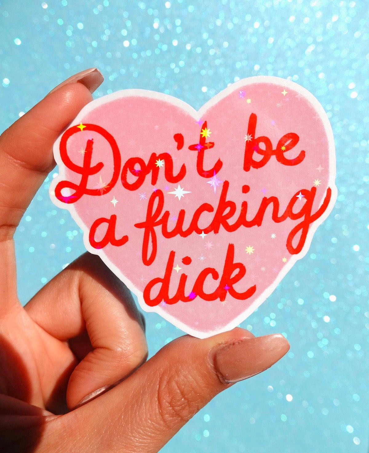 Funny Pink heart sticker with red script text: Don't be a fucking dick