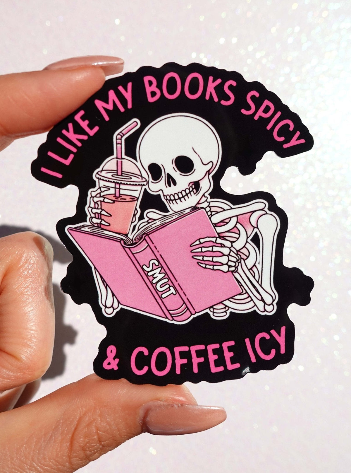 Funny Spicy & Coffee Icy book-themed sticker with skull holding a drink and book