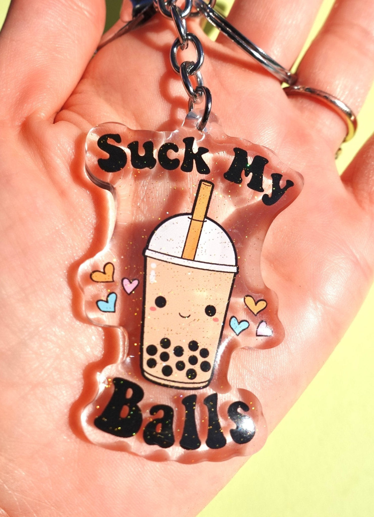 Funny Acrylic boba tea glitter keychain with 'Suck My Balls' text, cup, wavy red outline