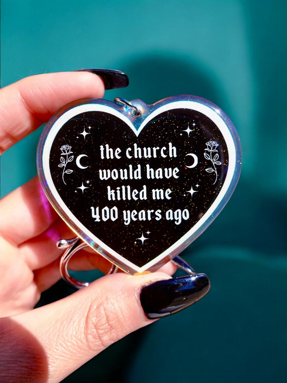 Funny Heart keychain with black glitter face, silver border, stars, and slogan text