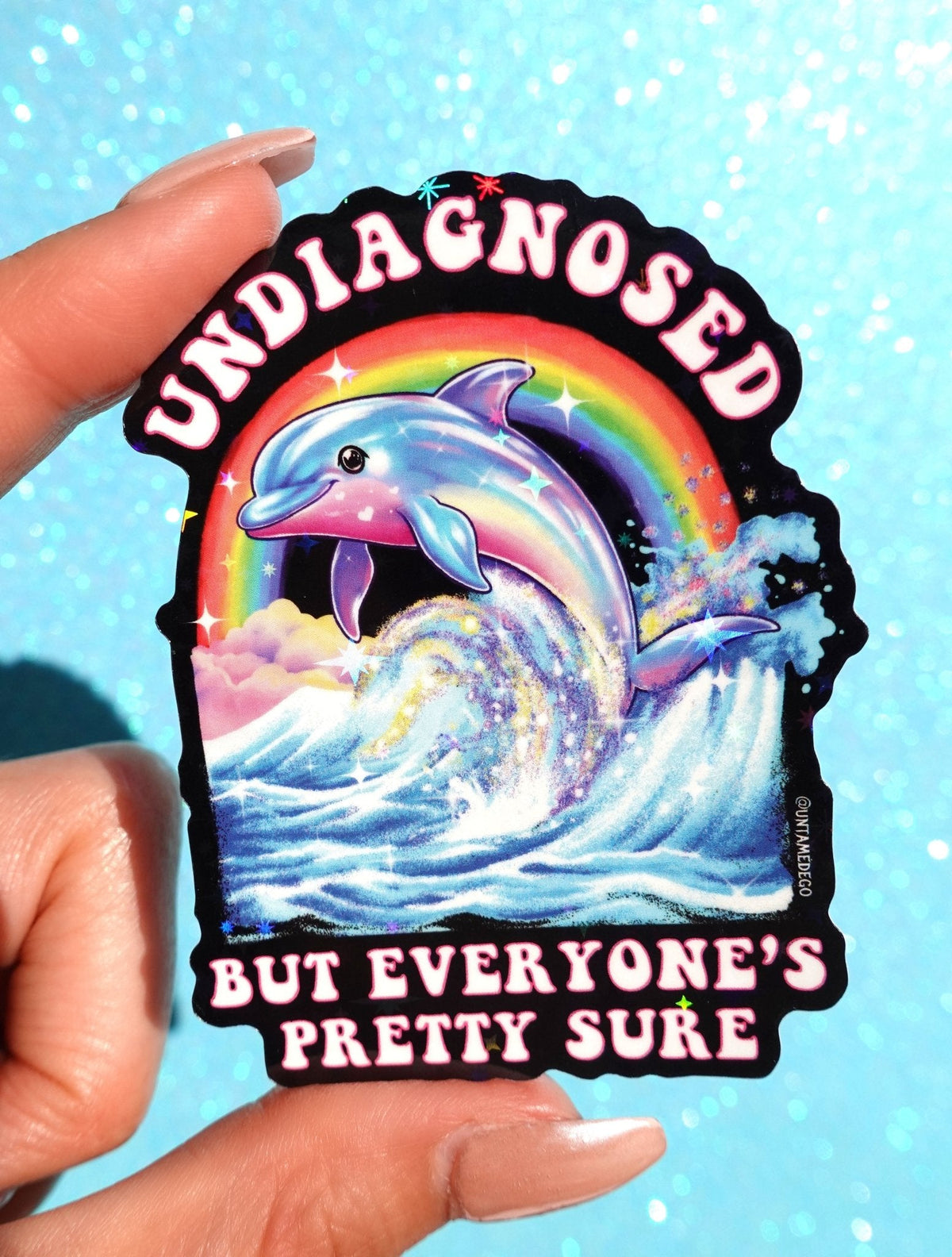 Funny Rainbow dolphin quote sticker with black border; reads 'Undiagnosed... pretty sure'.