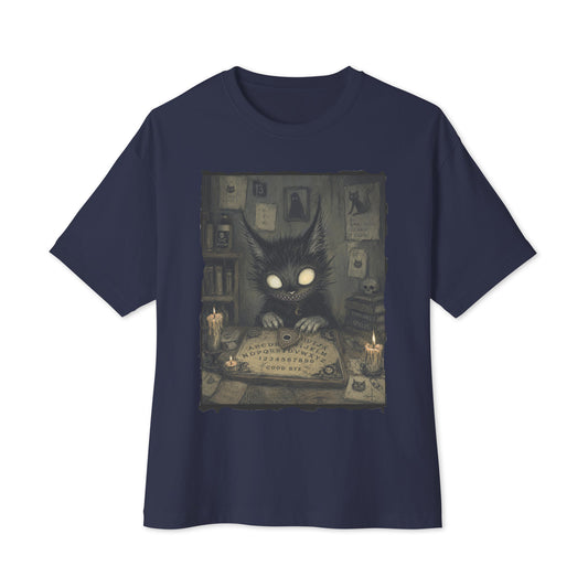 Navy oversized boxy tee with the 'Free Readings' goth graphic: a wide-eyed black cat creature at a Ouija board surrounded by candles