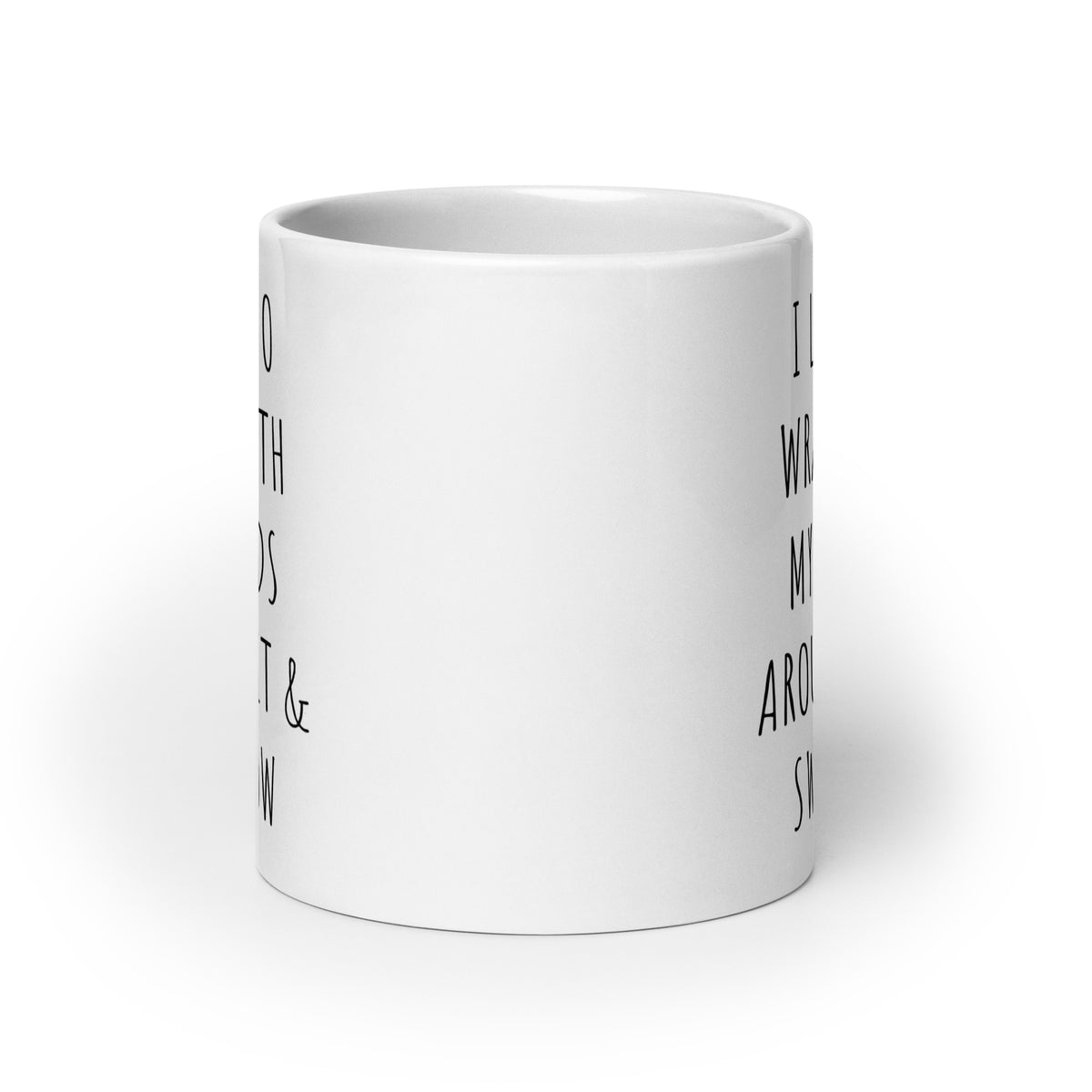 White glossy ceramic mug side view with partial black quote text on the body