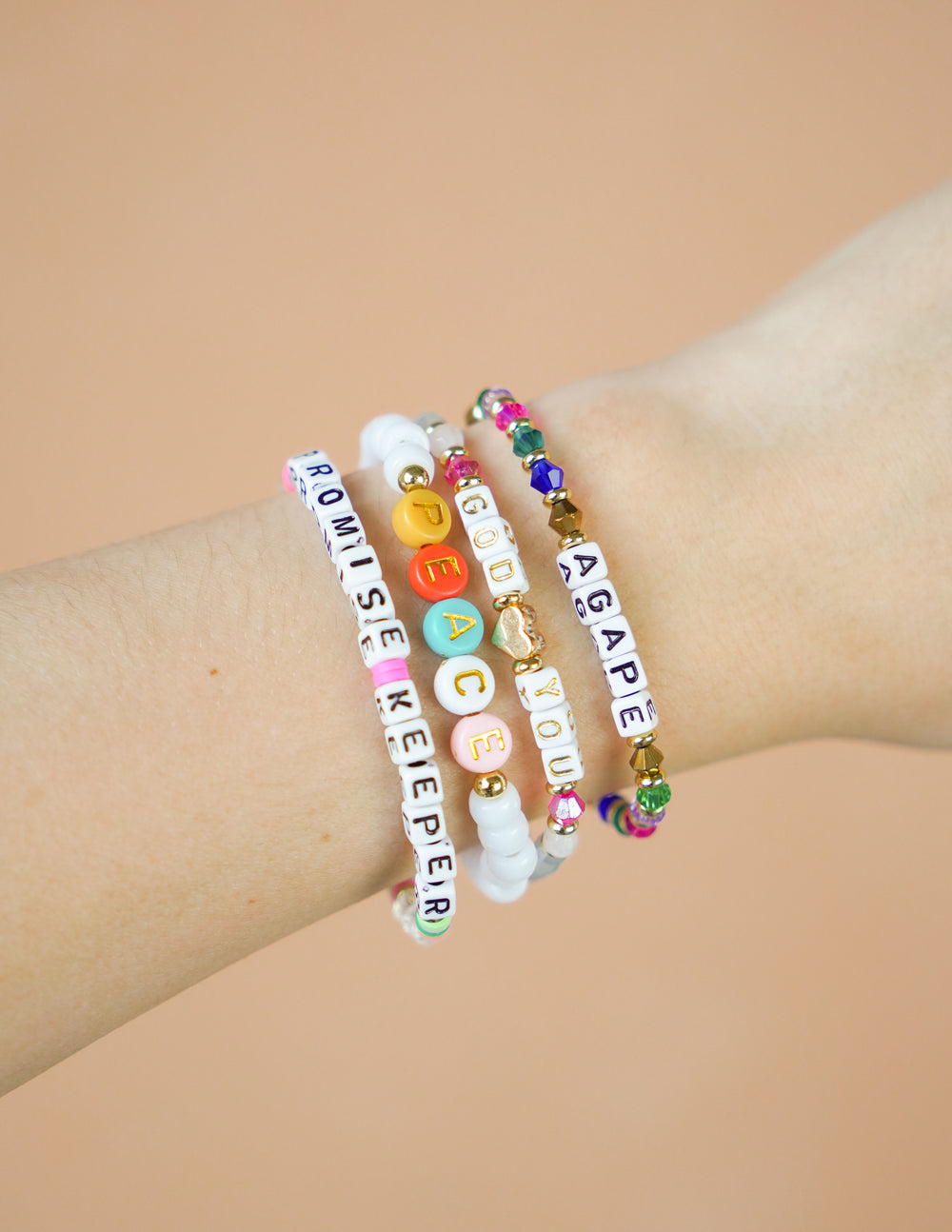 Colorful Elevated Faith Christian Jewelry Bracelet on a wrist with inspirational letters and beads