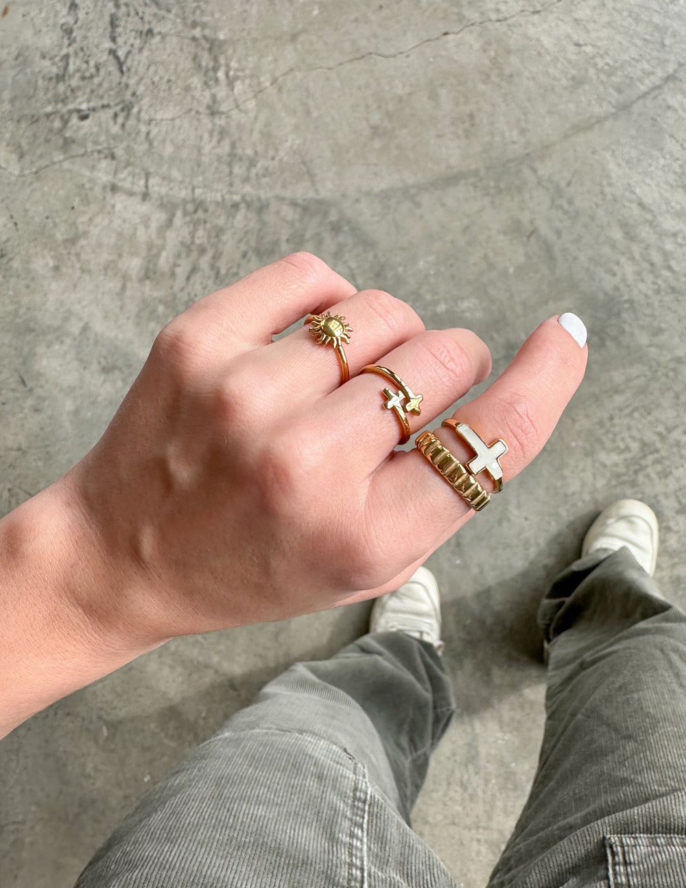 Collection of Elevated Faith Christian Jewelry rings worn on a hand with different designs and textures