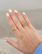 Gold Christian Jewelry Rings Stacked on Hand with Cross and Sun Design for Faith-Inspired Fashion