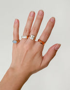 Set of Elevated Faith Christian Jewelry rings displayed on a hand, featuring various designs and messages