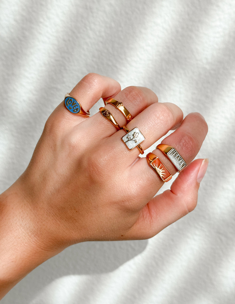 Elegant Christian Jewelry rings collection displayed on a hand with diverse designs and colors
