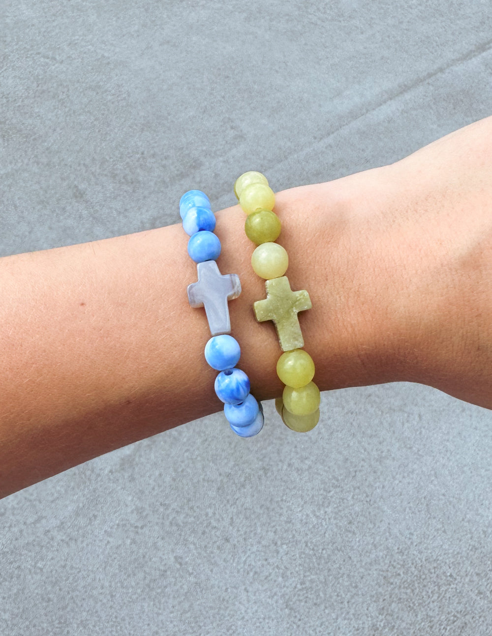 Elevated Faith Christian Jewelry Bracelet featuring blue and green stone crosses on a wrist