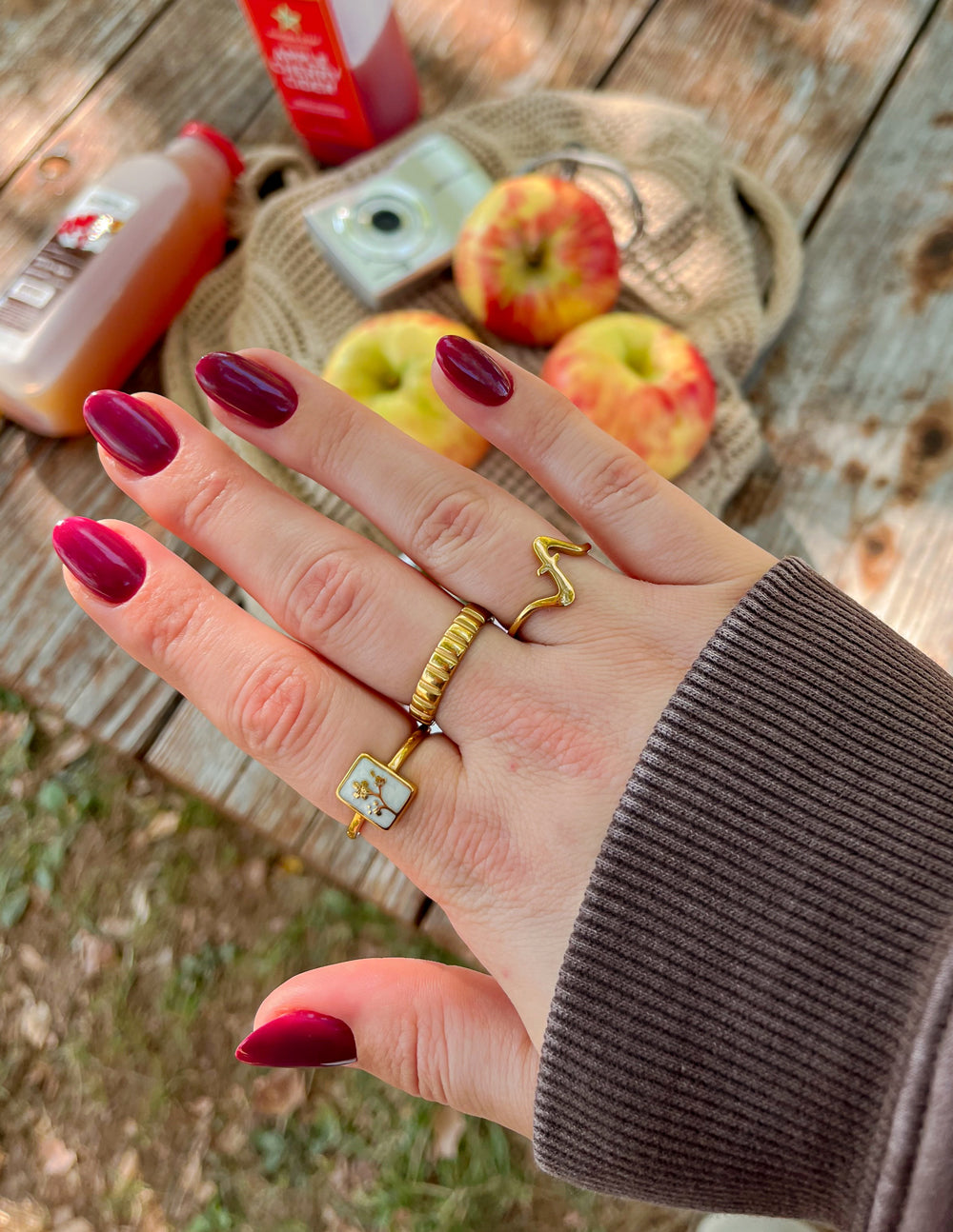 Elevated Faith Christian Jewelry ring displayed on a hand with apple and drink background