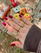 Elevated Faith Christian Jewelry ring displayed on a hand with apple and drink background