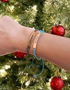 Elevated Faith Christian Jewelry Bracelet displayed on a wrist, featuring colorful string and inspirational engraving