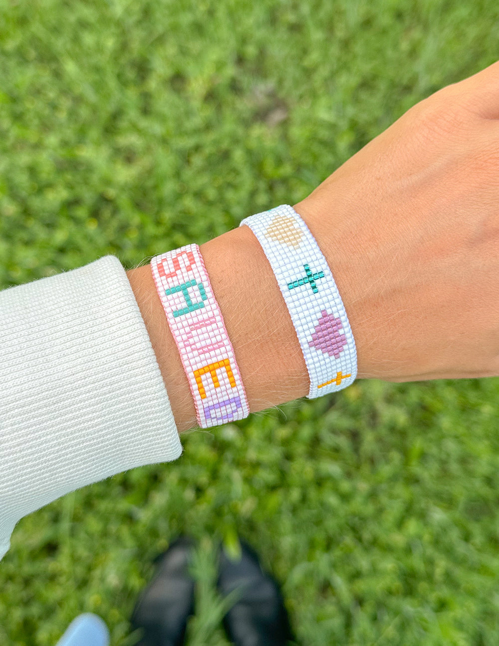 Elevated Faith Christian Jewelry Bracelet with colorful letters and symbols on a woven design