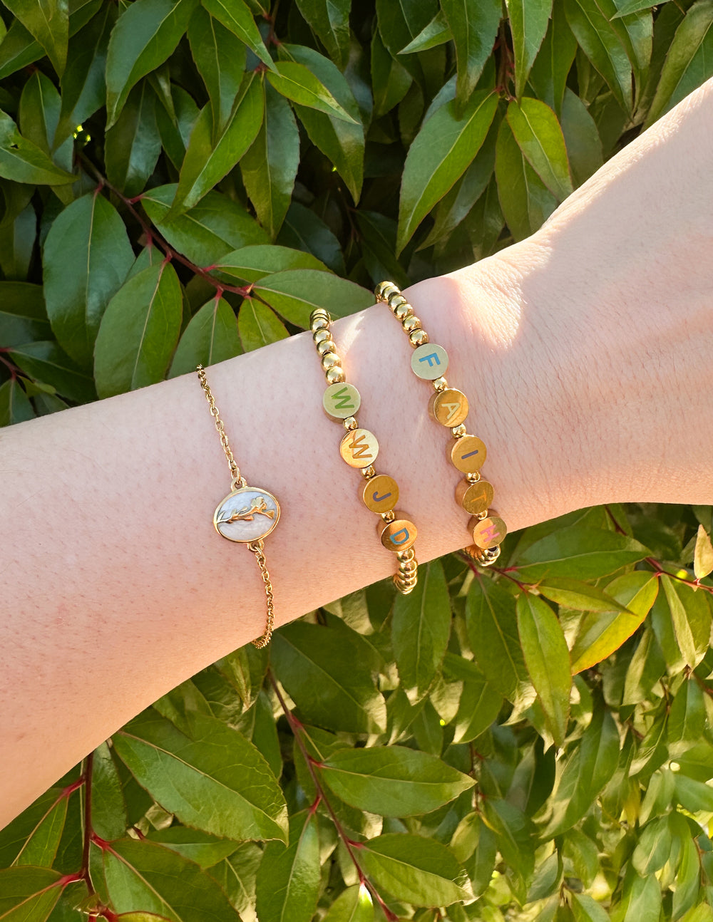 Three stylish Elevated Faith Christian Jewelry Bracelets featuring unique charms and affirming messages