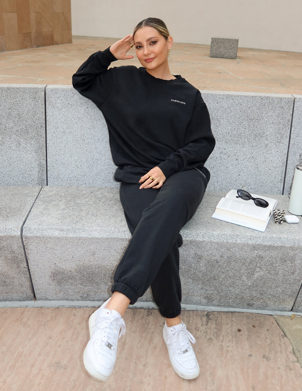 Elevated Faith Christian Crewneck Sweatshirt in black, styled casually with matching pants