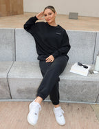 Elevated Faith Christian Crewneck Sweatshirt in black, styled casually with matching pants