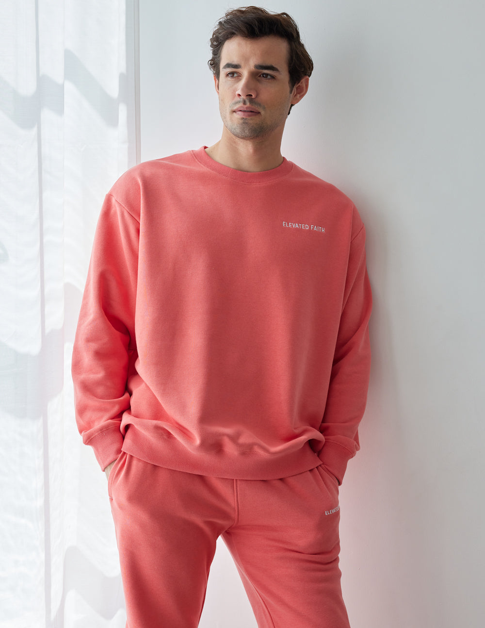 Elevated Faith Christian Crewneck Sweatshirt in vibrant coral color for casual comfort and style