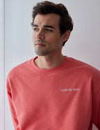 Elevated Faith Coral Christian Crewneck Sweatshirt featuring a simple logo for comfortable faith-based style