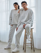 Casual couple wearing Elevated Faith Christian Crewneck Sweatshirt in light gray, styled with matching pants