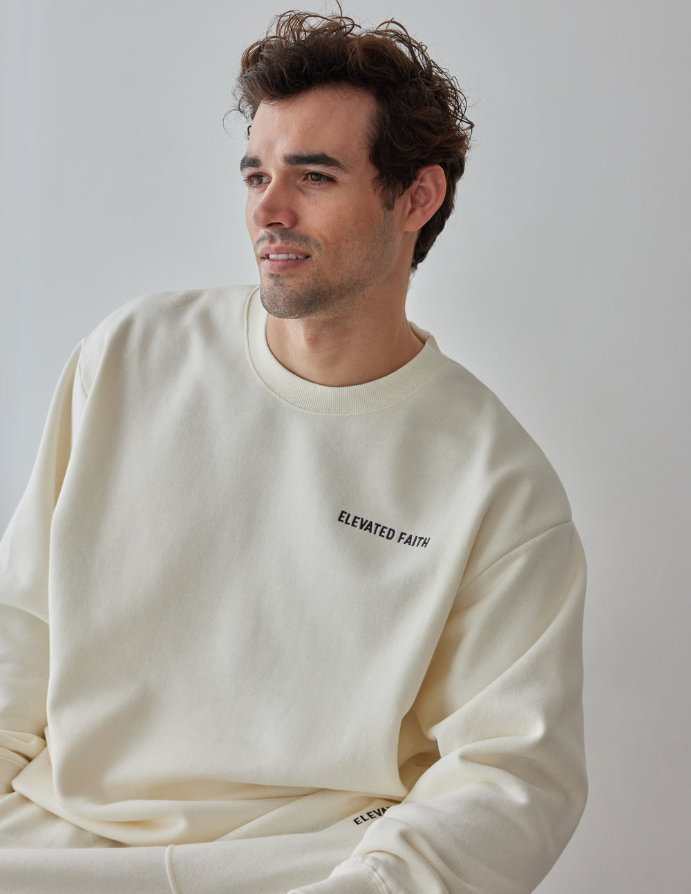 Elevated Faith Christian Crewneck Sweatshirt in cream color with stylish logo design