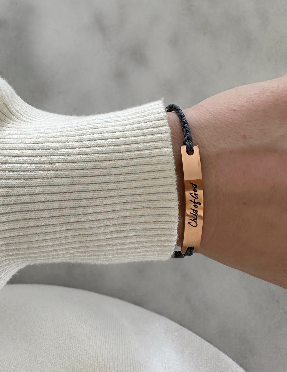 Elevated Faith Christian Jewelry Bracelet with a copper tag and braided string for a stylish faith accessory