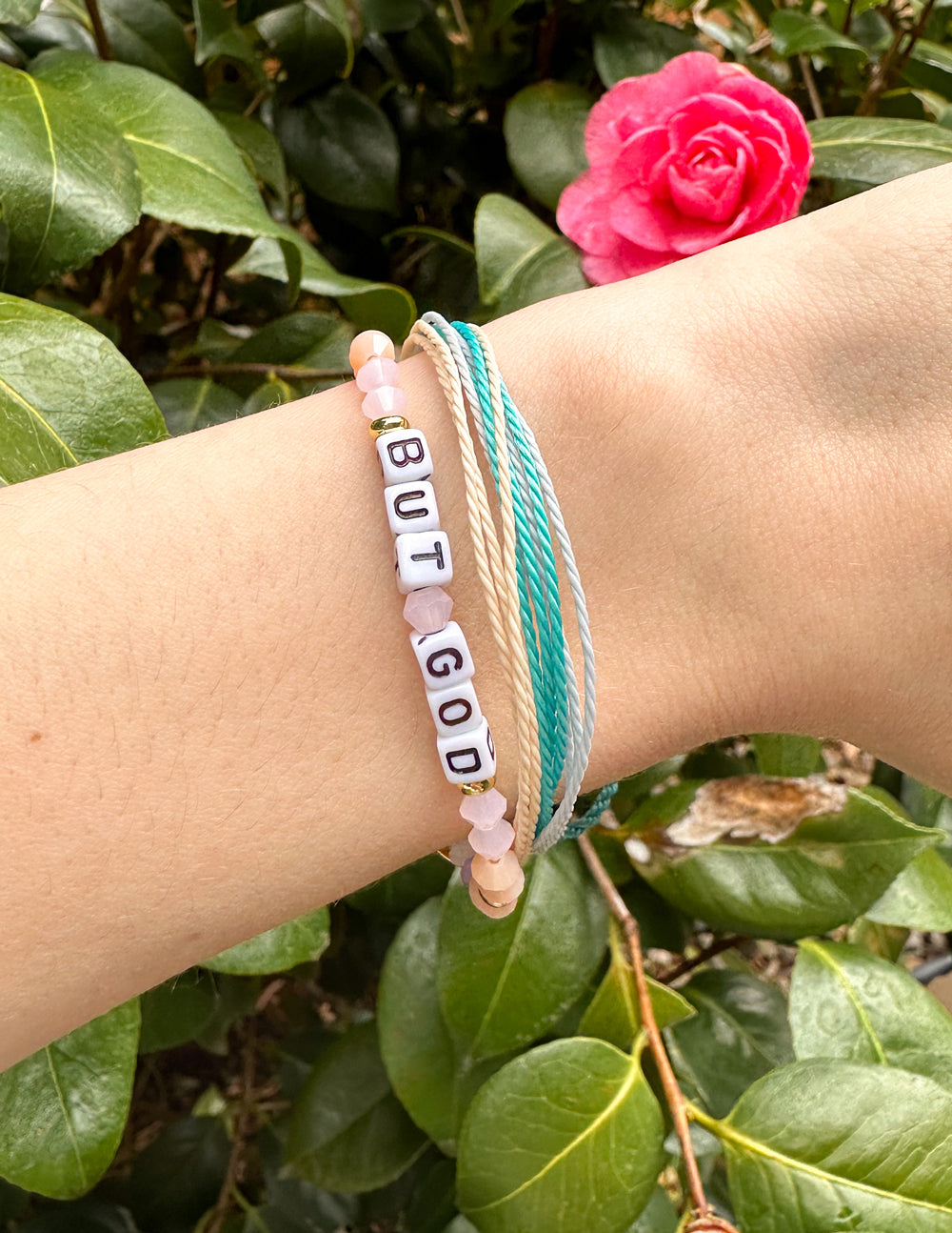 Elevated Faith Christian Jewelry Bracelet with letters spelling 'BUT GOD' on a stylish layered design