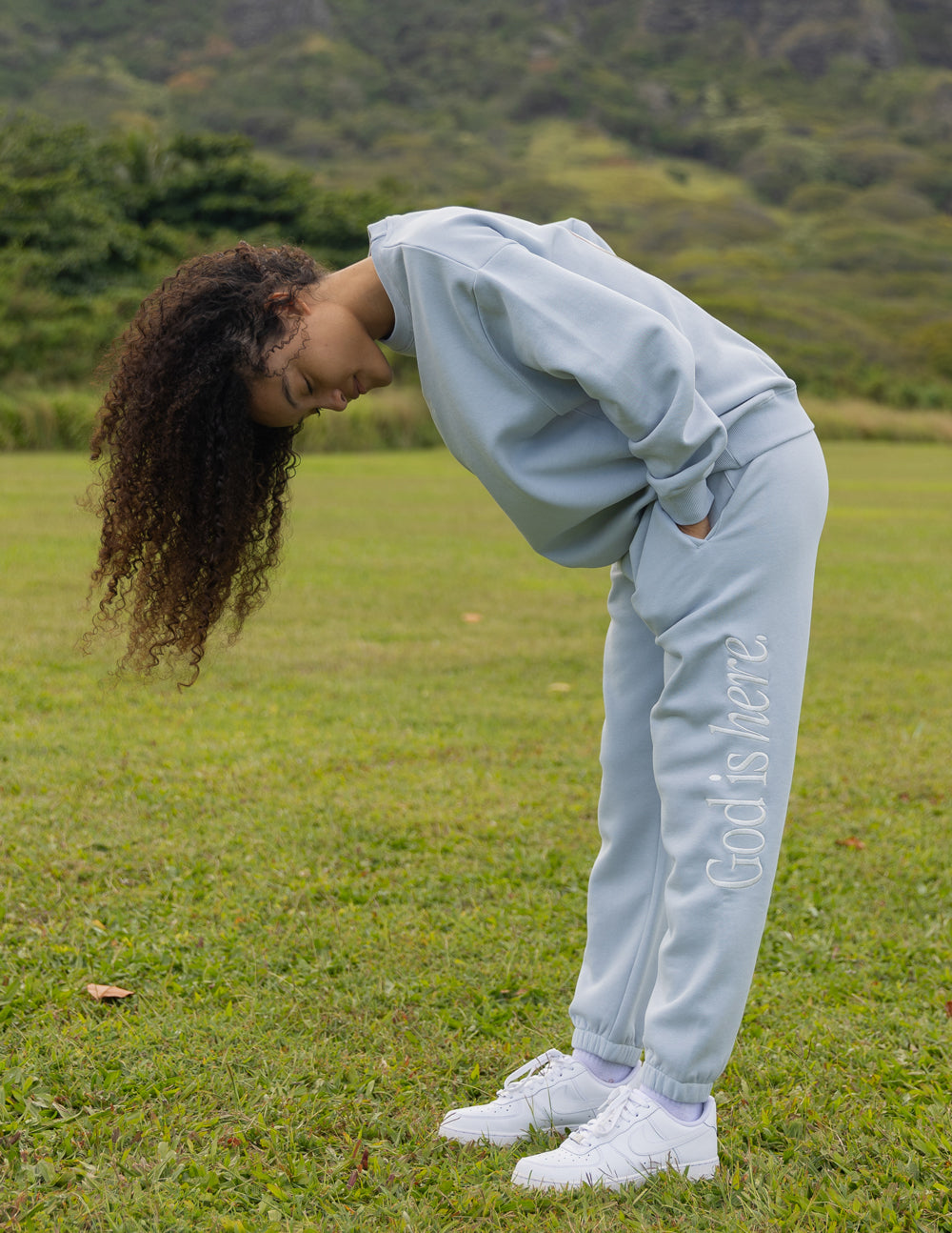 Light blue sweatpants from Elevated Faith featuring 'God is Never' design, perfect for Christian Apparel