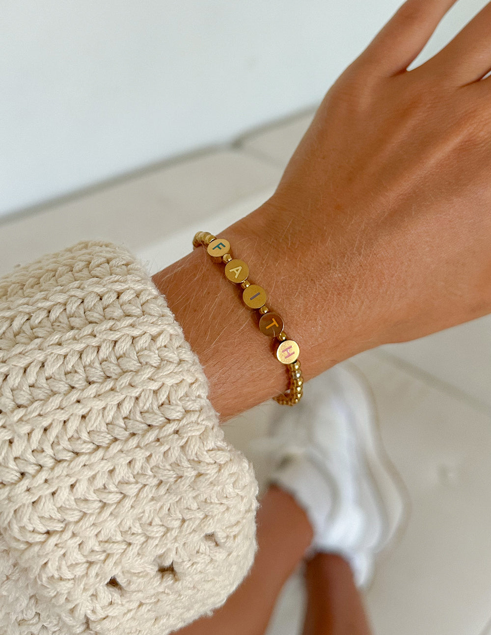 Elevated Faith Christian Jewelry Bracelet featuring gold letters spelling 'FAITH' on a delicate chain