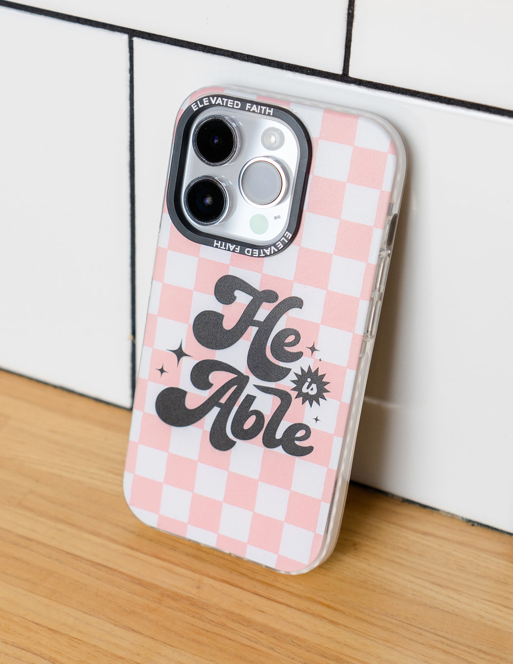 Elevated Faith Christian iPhone Case with a pink checkerboard design and motivational quote 'He Able'