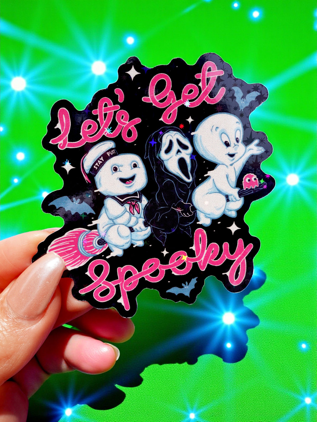 Funny Halloween sticker with cute ghost and bat icons and pink “Let’s Get Spooky” text