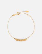 Elevated Faith Christian Jewelry Bracelet with gold chain and beads spelling 'LOVED'