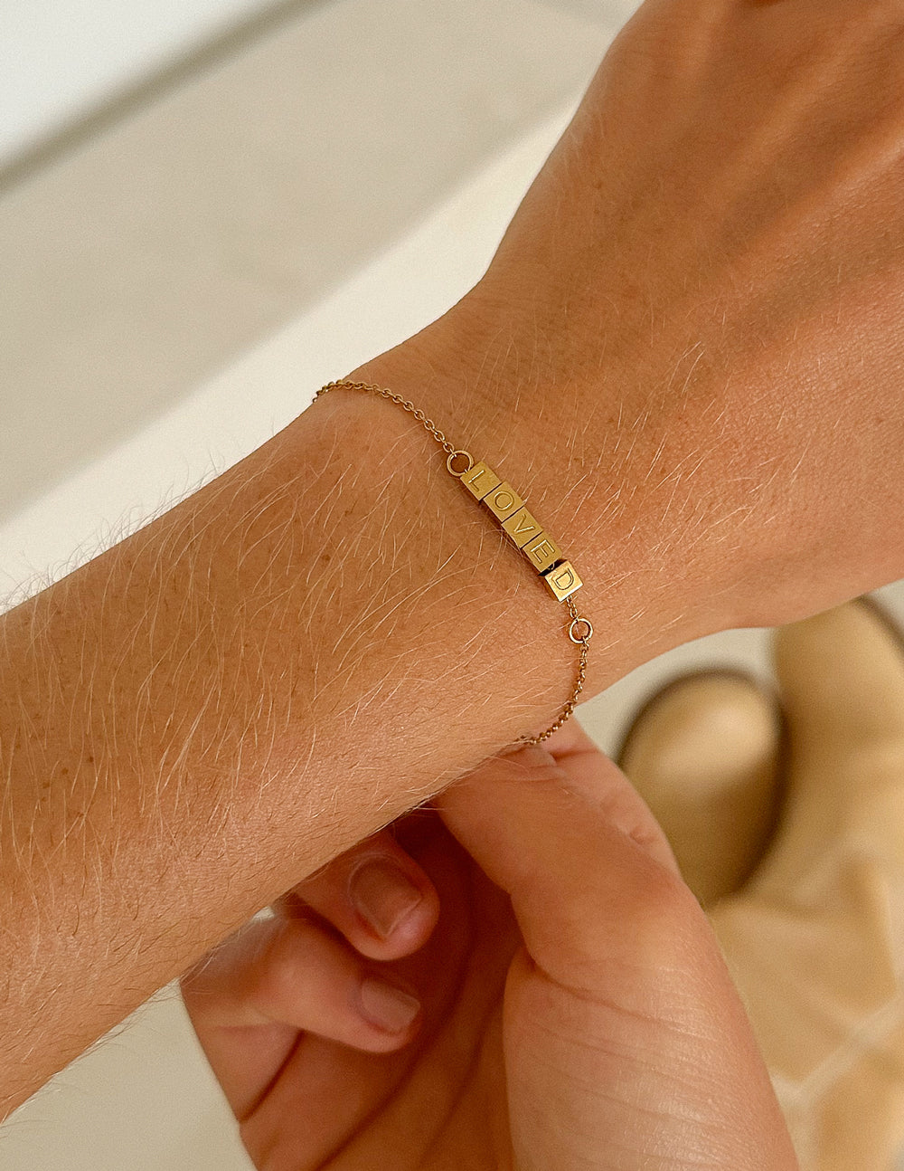 Elevated Faith Christian Jewelry Bracelet with gold letters spelling 'LOVE' on a delicate chain