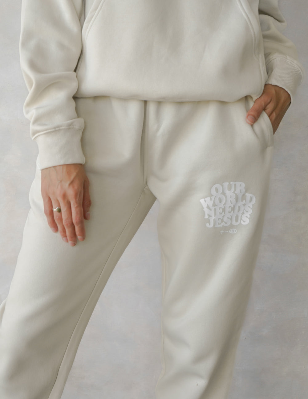 Elevated Faith cream sweatpants featuring a motivational print, perfect for Christian Apparel enthusiasts