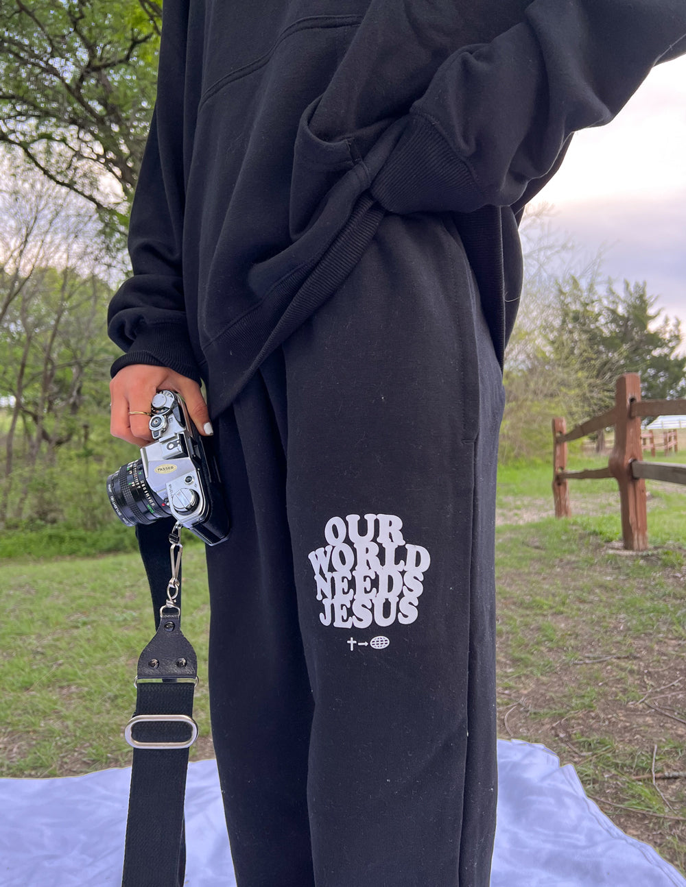 Black Elevated Faith Sweatpants with 'Our World Needs Jesus' Print for Christian Apparel Enthusiasts