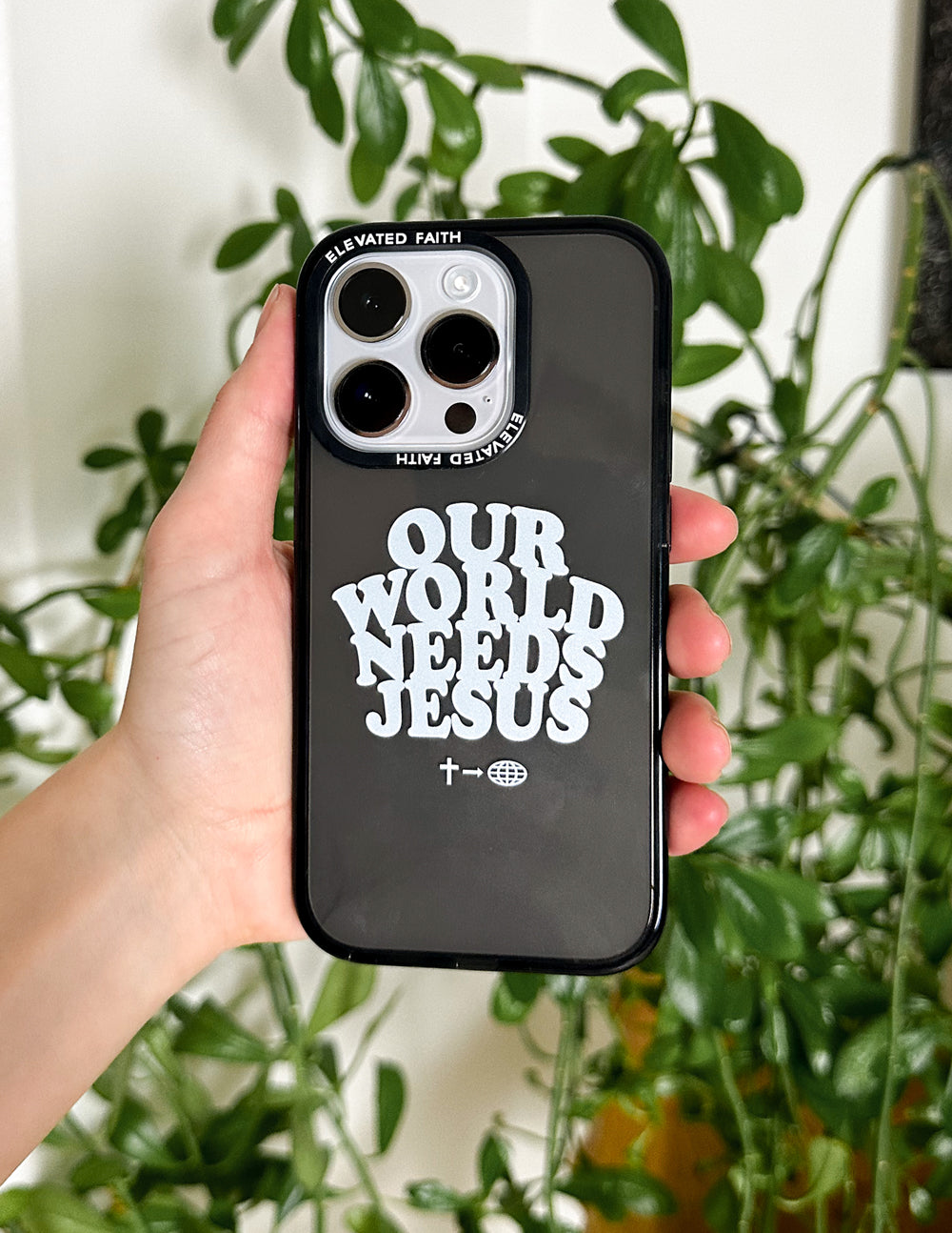 Elevated Faith Christian iPhone Case with 'Our World Needs Jesus' design on a sleek black background