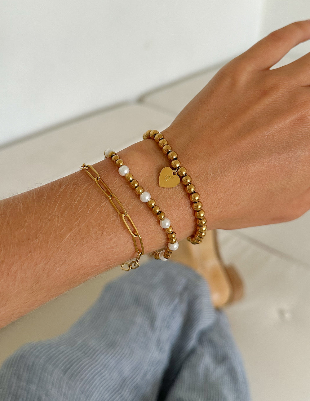 Stylish Christian Jewelry Bracelet featuring gold beads and a heart charm for a faith-inspired look