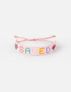 Pink Beaded Christian Jewelry Bracelet with 'SAVED' and heart designs for faith-inspired style