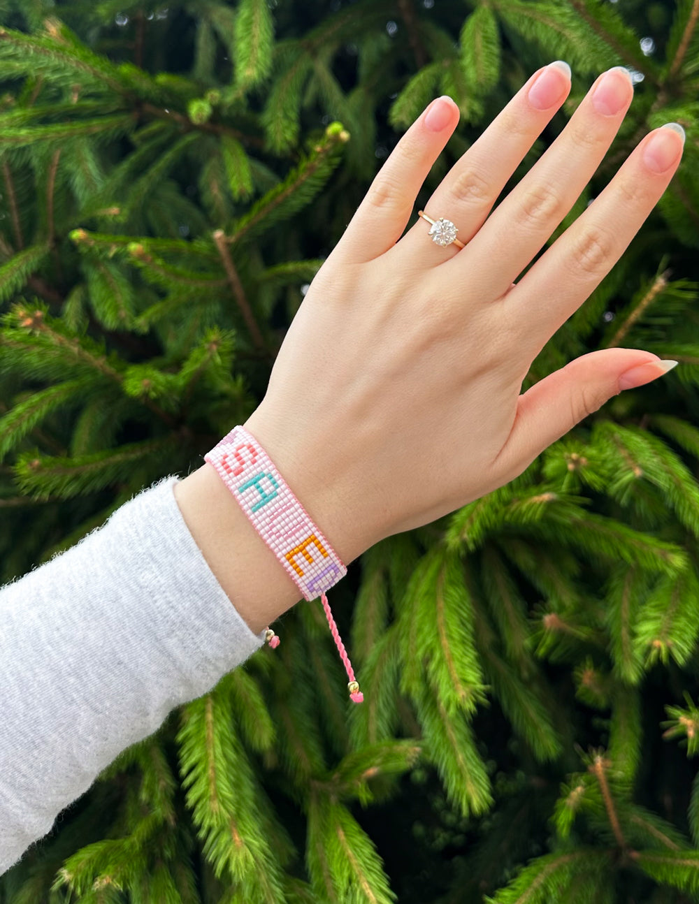Elevated Faith Christian Jewelry Bracelet on a hand against a green background for stylish wear