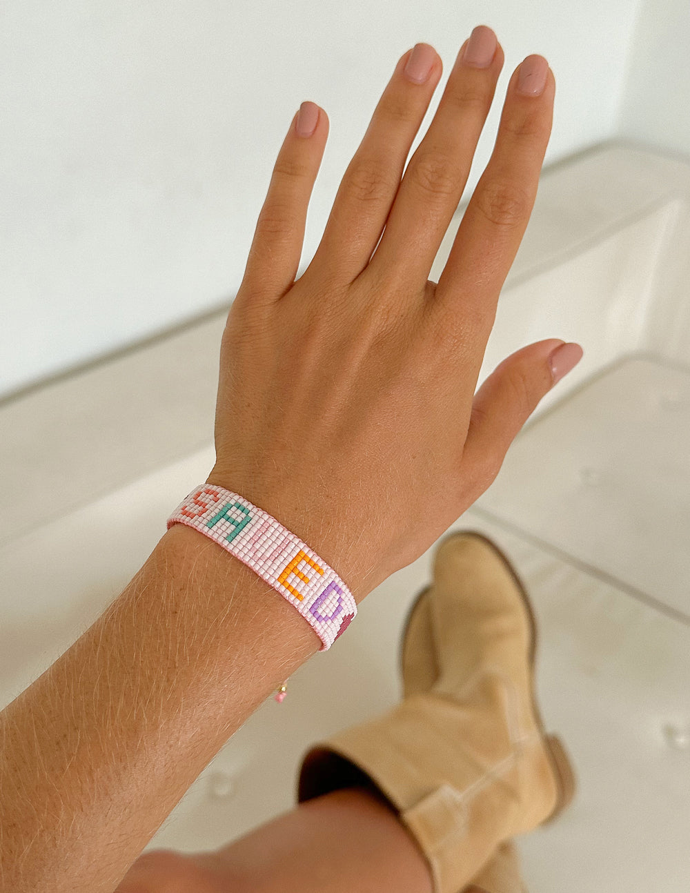 Elevated Faith Christian Jewelry Bracelet on a hand, featuring colorful beads and a unique design