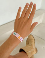 Elevated Faith Christian Jewelry Bracelet on a hand, featuring colorful beads and a unique design
