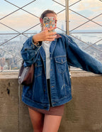 Elevated Faith Christian iPhone Case held in hand with skyline view in the background