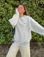 Woman in a gray Christian Crewneck Sweatshirt with oversized fit and relaxed style outdoors