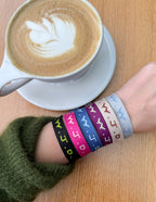 Colorful Elevated Faith Christian Jewelry Bracelet worn on wrist next to a coffee cup