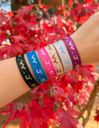 Elevated Faith Christian Jewelry Bracelet collection with multiple vibrant colors displayed outdoors