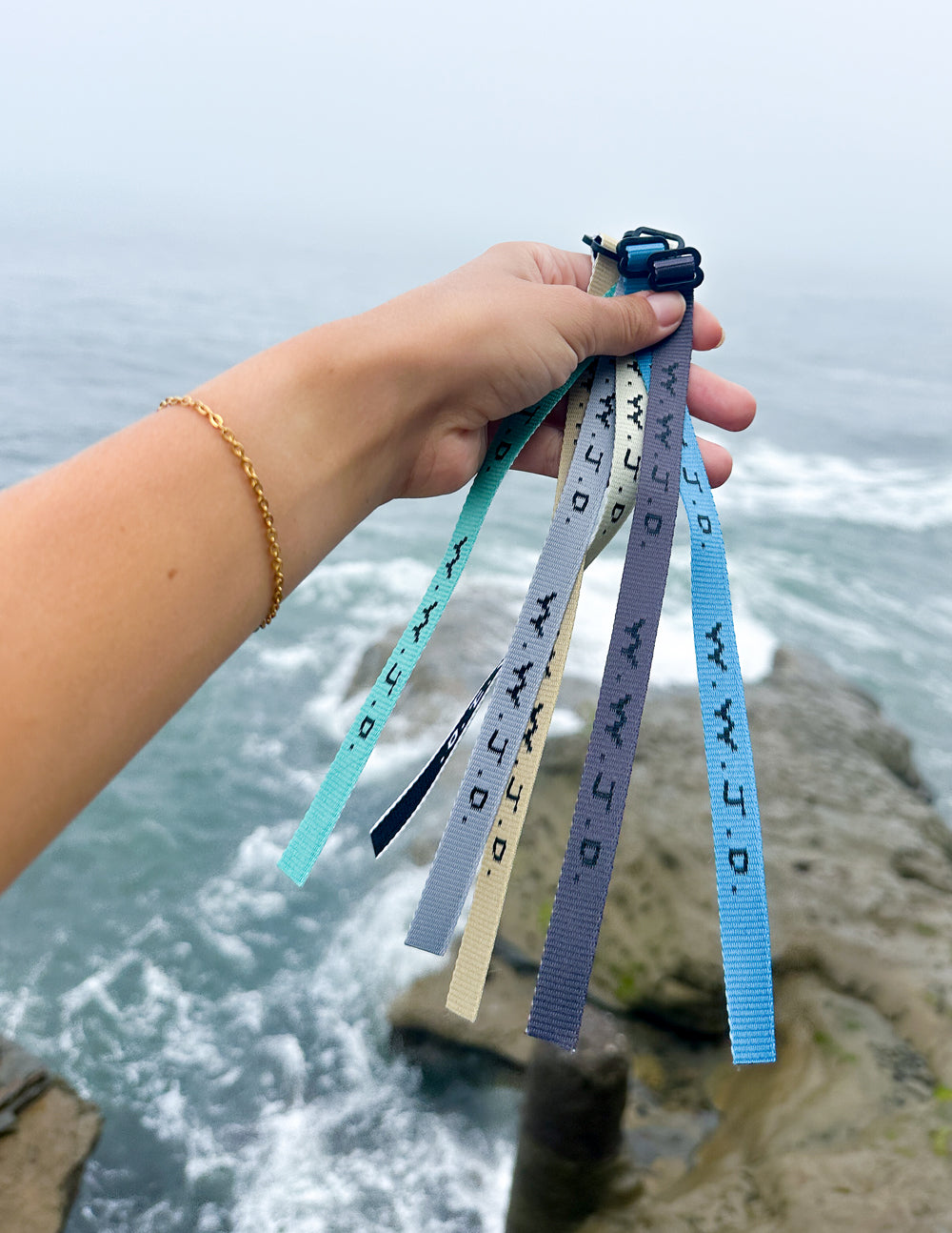 Elevated Faith Christian Jewelry Bracelet collection featuring colorful wristbands by the ocean