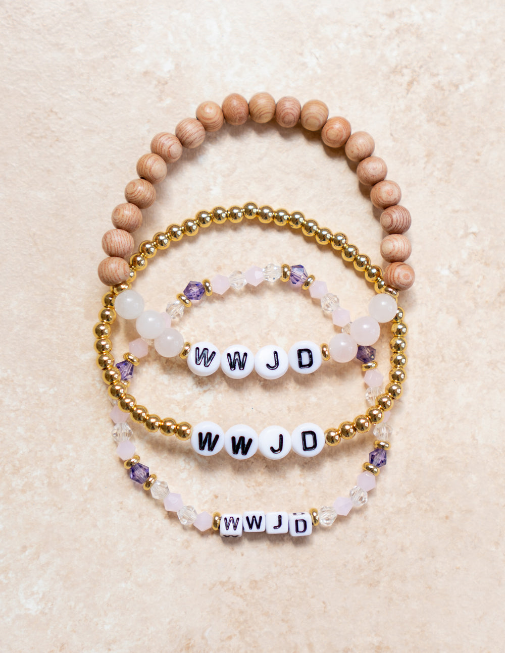Set of WWJD Christian Jewelry Bracelets featuring beads in natural wood and gold with decorative accents