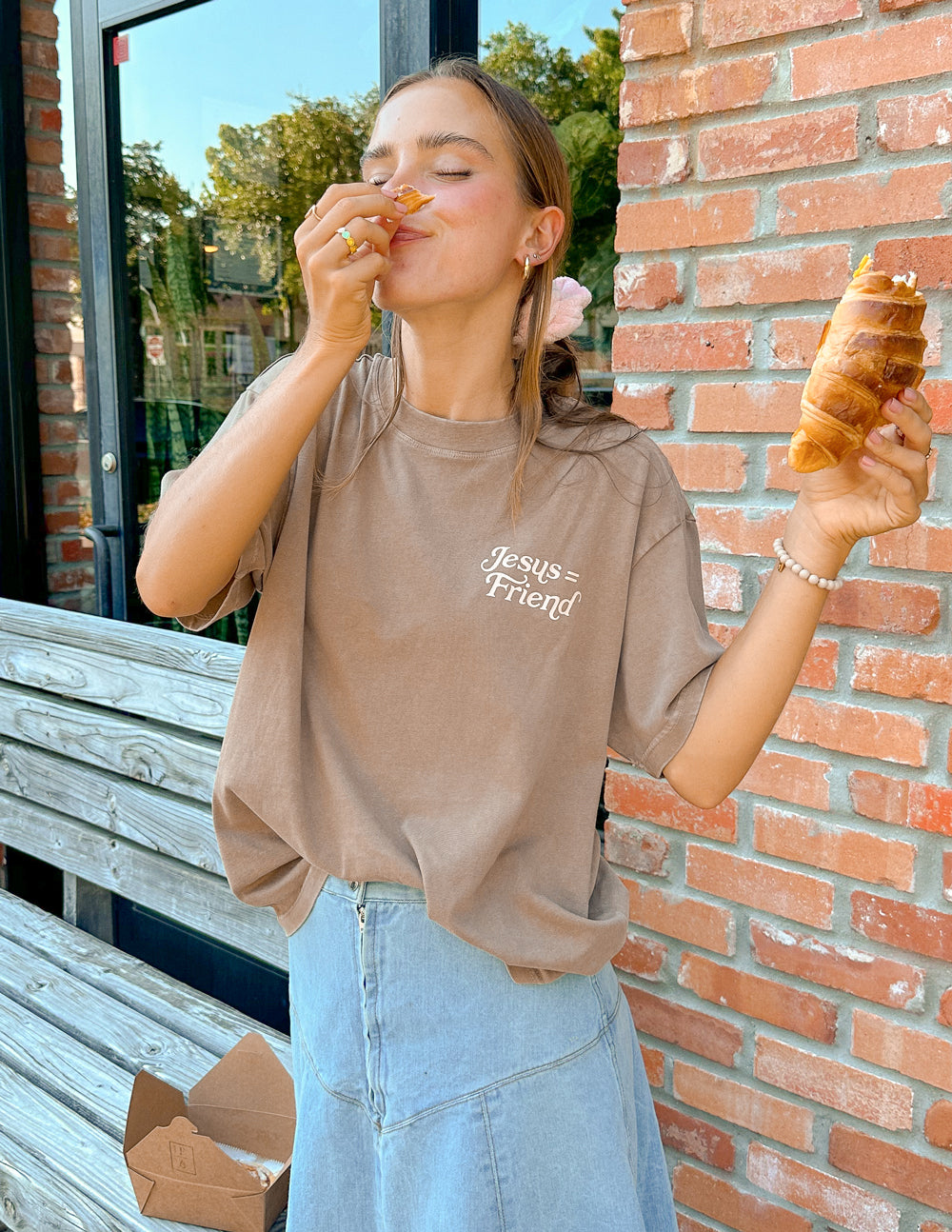 Elevated Faith Christian Apparel T-Shirt in brown with Jesus Friend graphic worn casually outdoors