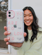 Elevated Faith Christian iPhone Case with inspirational text and clear backing held by a smiling woman