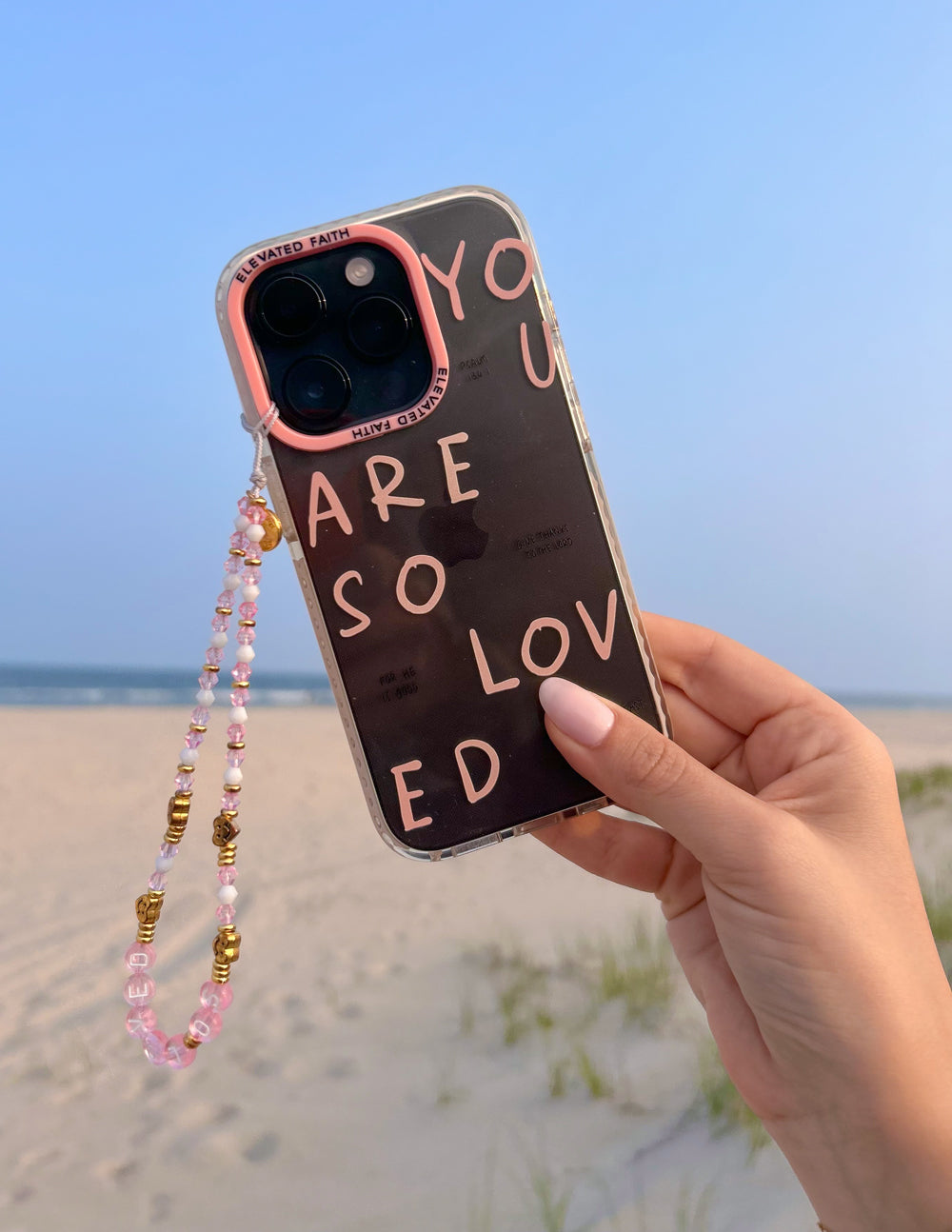 Christian iPhone Case with colorful text 'You Are So Loved' and a decorative beaded strap
