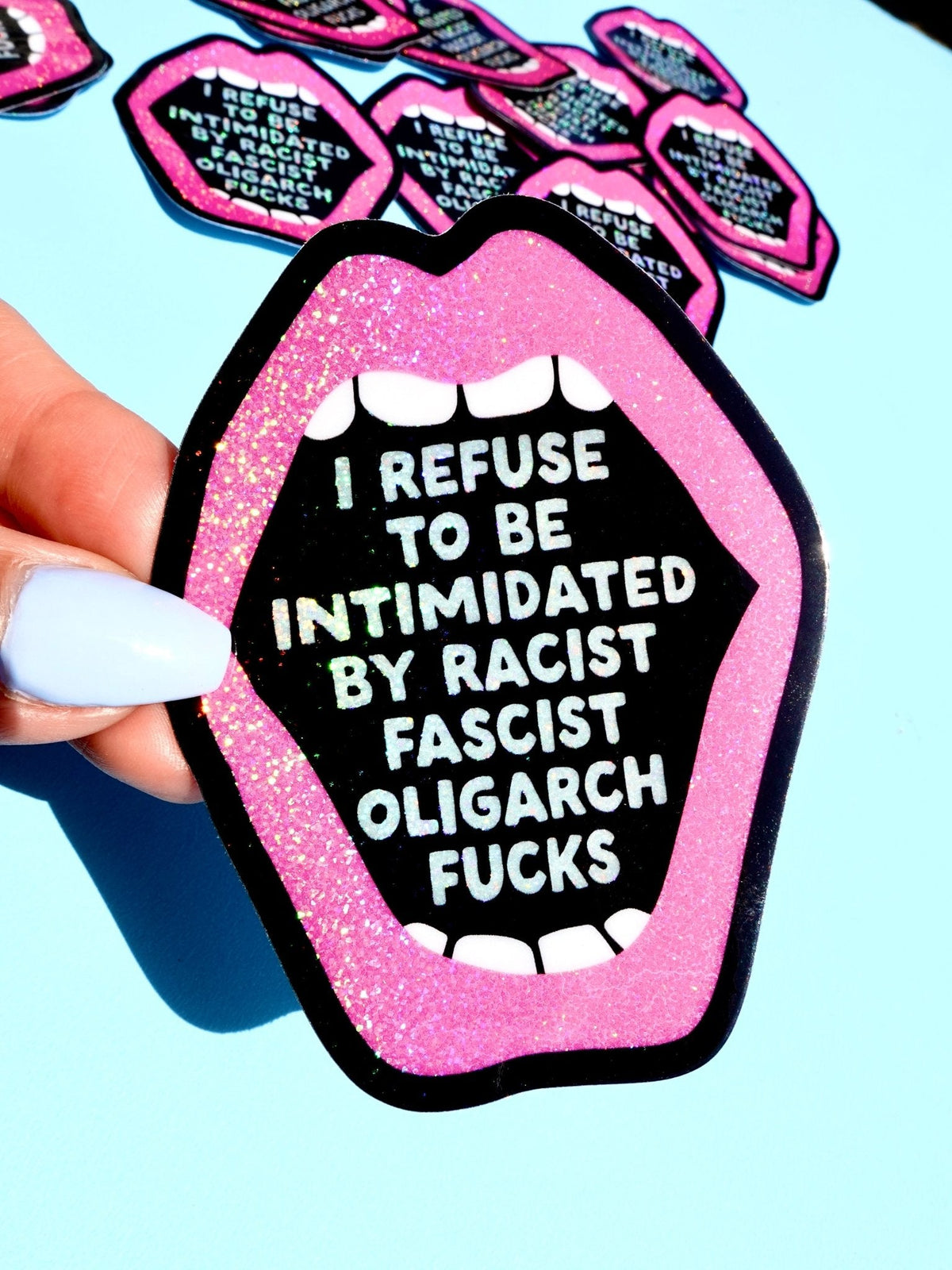Funny Lip-shaped statement sticker with pink glitter border and white anti-fascist text on black